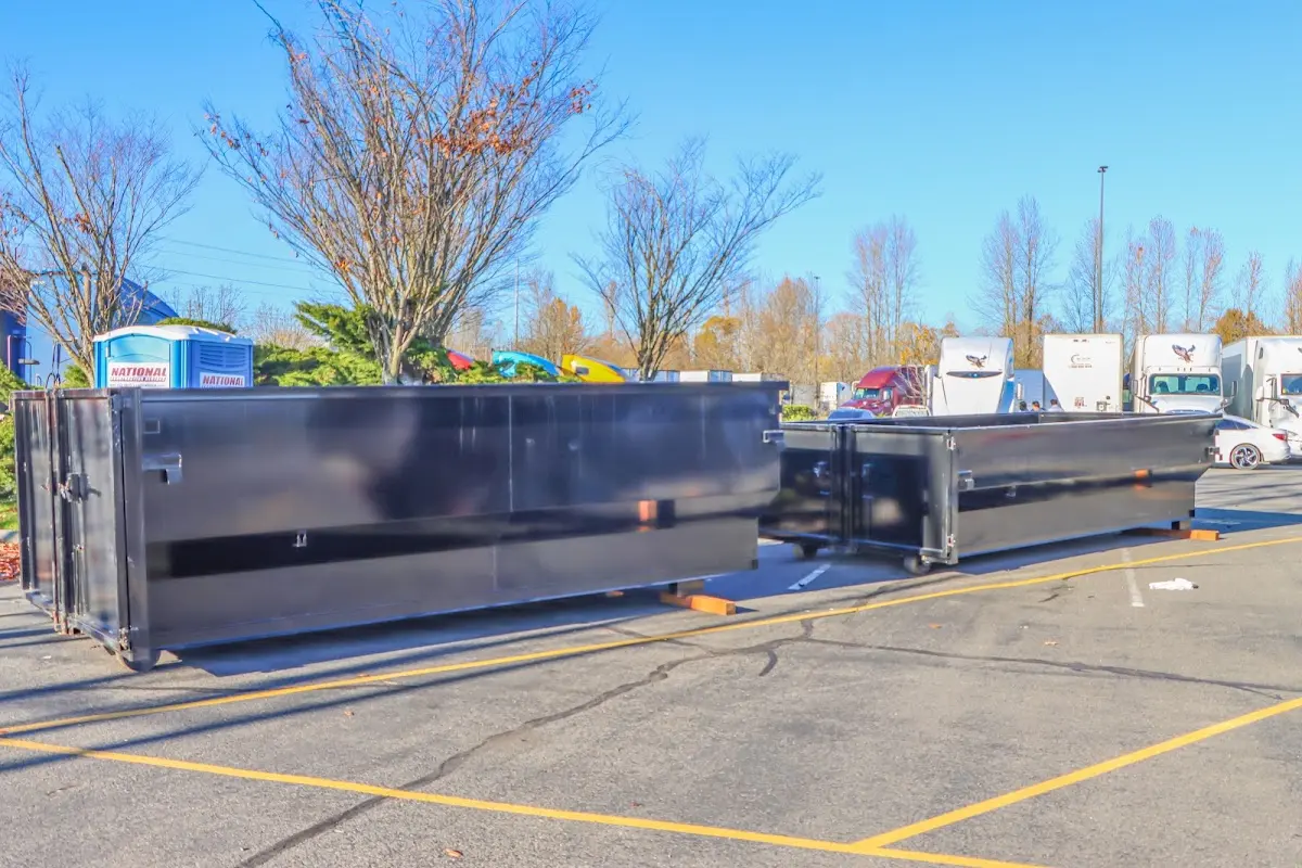 Professional dumpster rental service with roll-off container on residential driveway in West Modesto